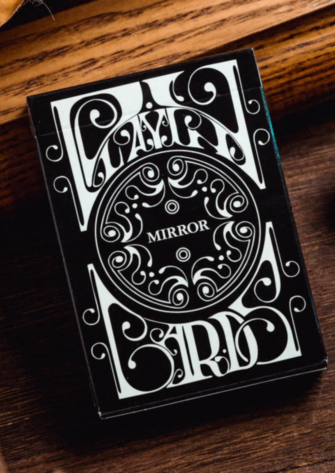 Back in print for the first time in nearly 10 years. The cards feature an updated back design based on the original edition released in 2008, complete with minimal court cards, custom jokers, and an intricate ace of spades.  Printed by the United States Playing Card Company. Available in the original white (Smoke) and black (Mirror)